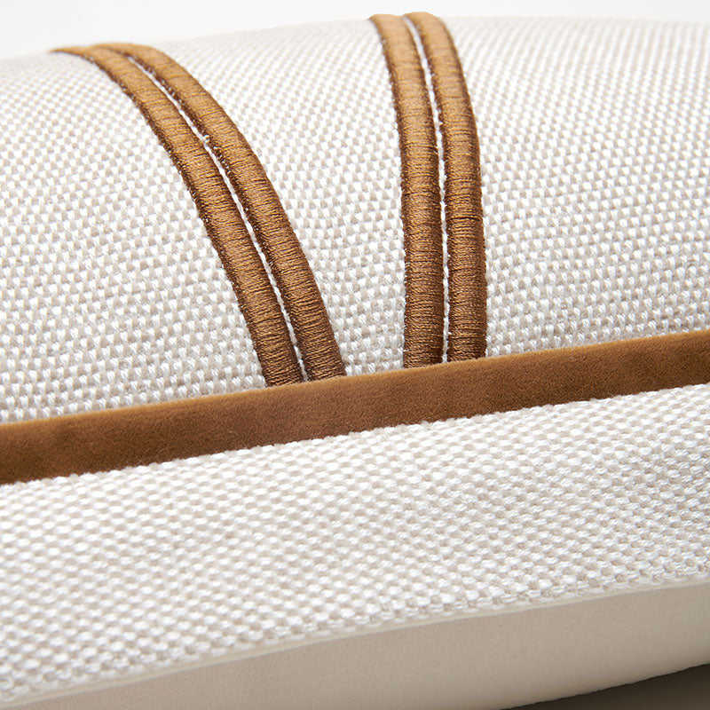 close-up-of-a-woven-cushion-or-pillow-in-off-white-fabric-with-two-vertical-tan-stitched-bands-and-a-matching-tan-horizontal-trim