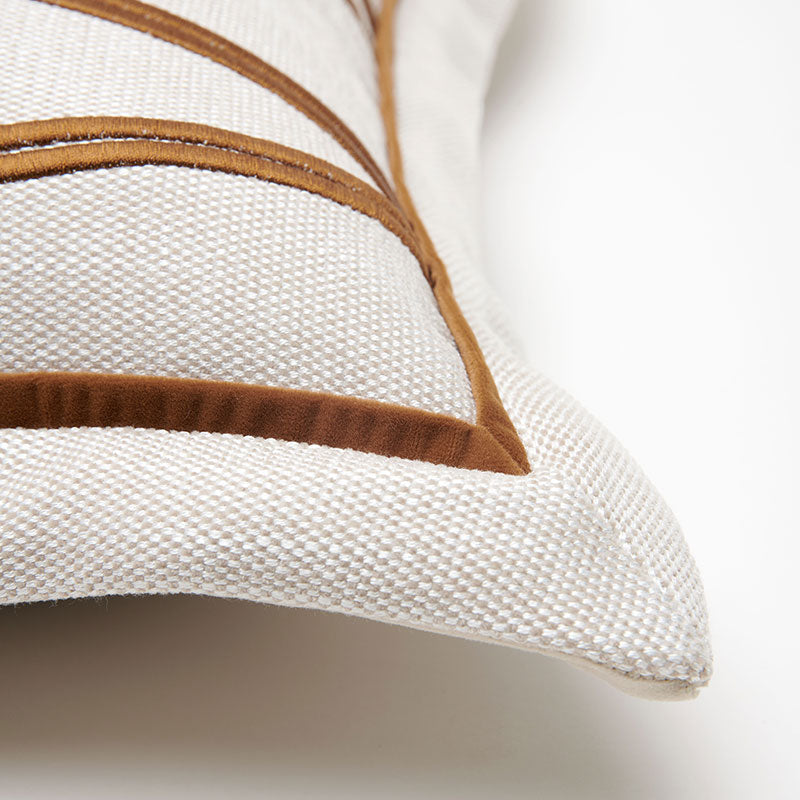 close-up-of-a-woven-throw-pillow-in-off-white-fabric-with-brown-embroidered-geometric-lines-shown-on-a-clean-white-background